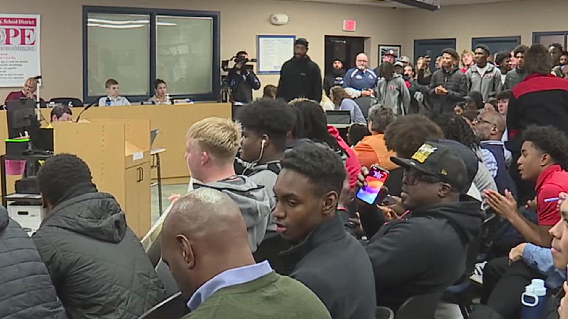 Dozens of community members speak out in support of coach Joe Headen, who was abruptly sacked by the school board despite a successful season.