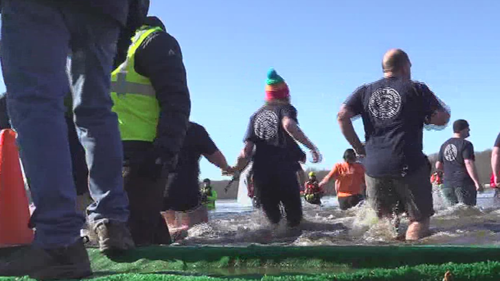 Plungers began at noon with 28-degree water, hours after volunteers used chainsaws to cut through 3 inches of ice to make space for the event.