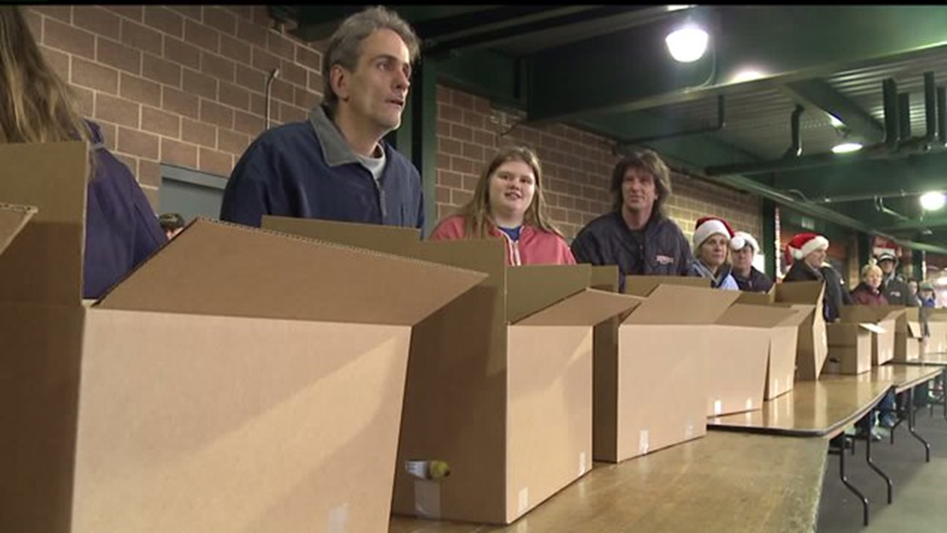 Thousands receive free Christmas meal boxes at Clipper Magazine Stadium