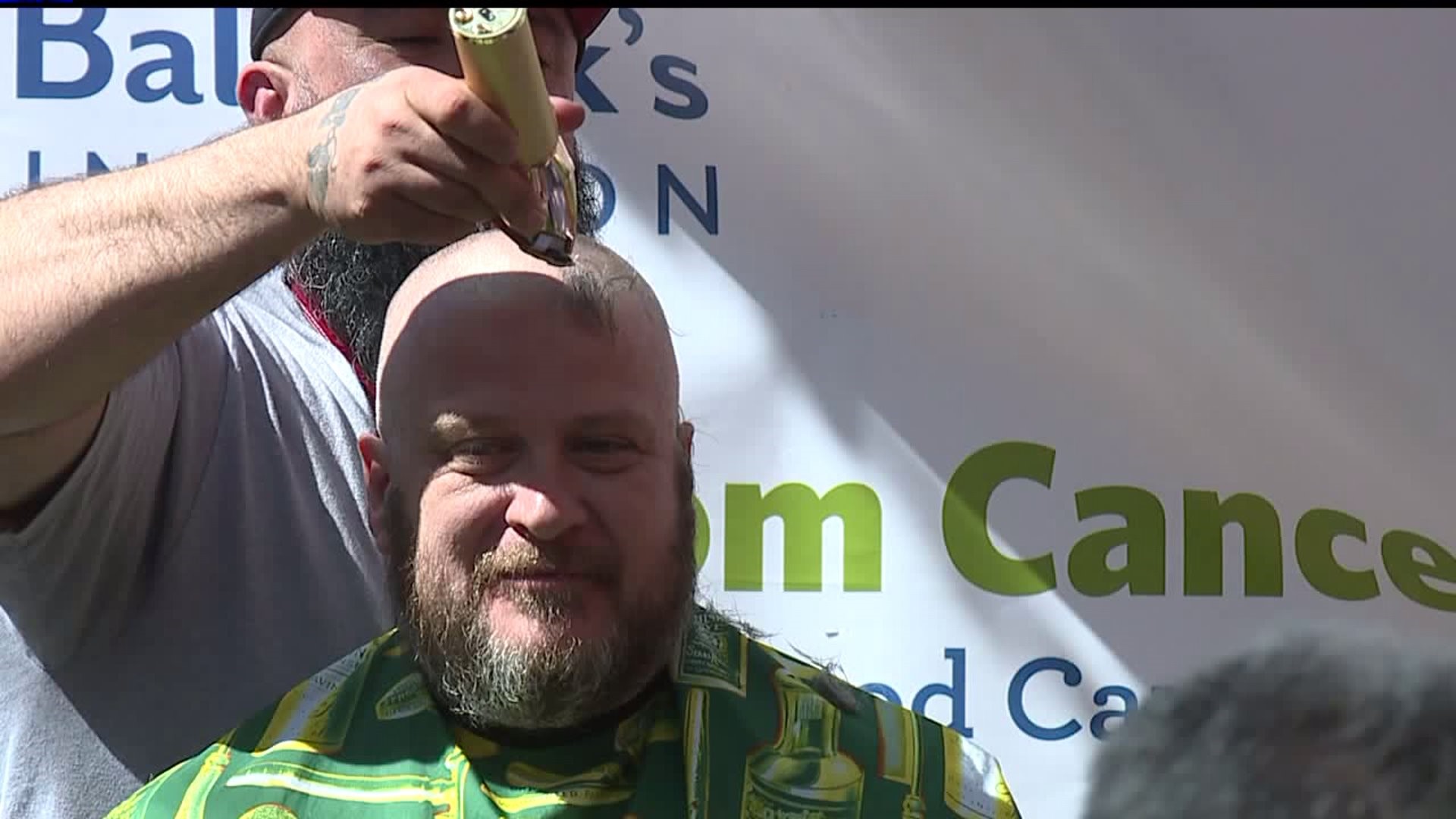 York City police and firefighters shave their heads for a good cause