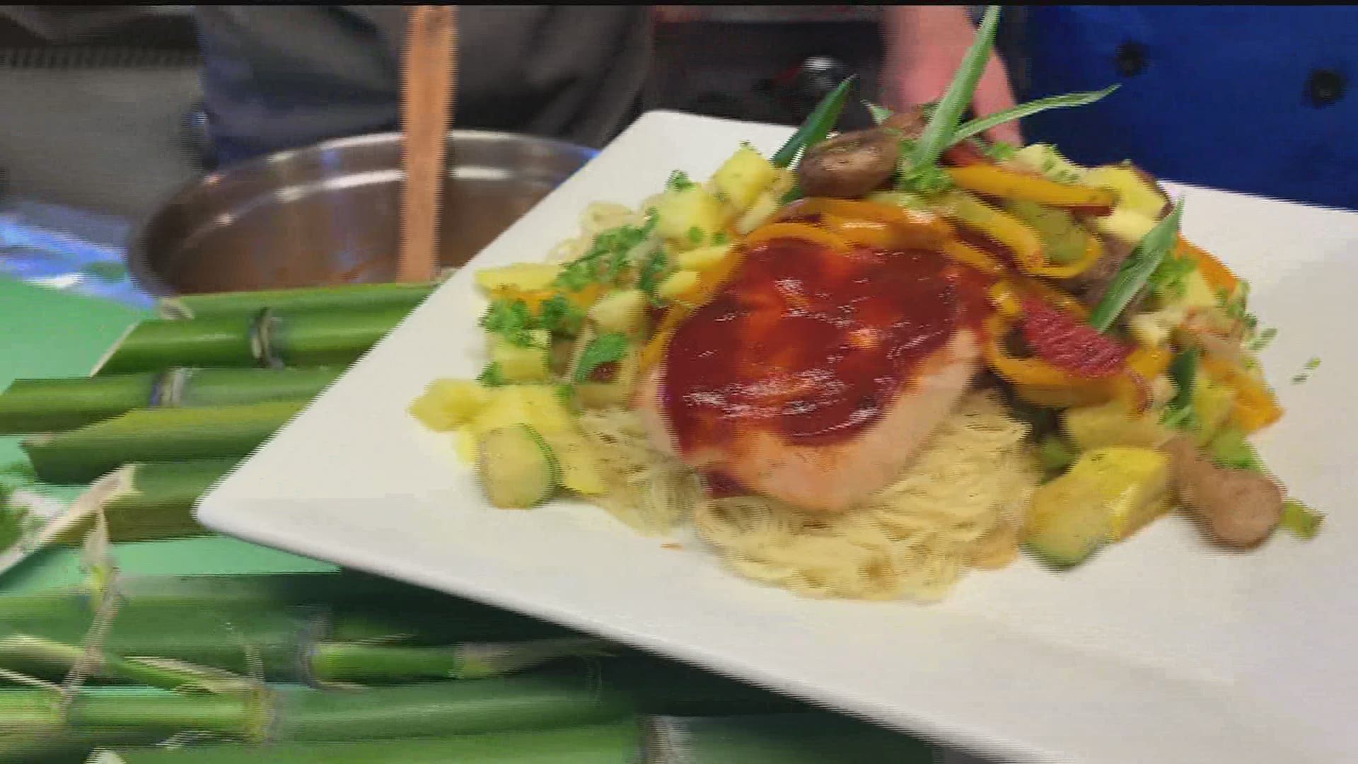 Fire grilled Salmon served with a veggie pasta stir-fry and topped w a fresh Pineapple Salsa