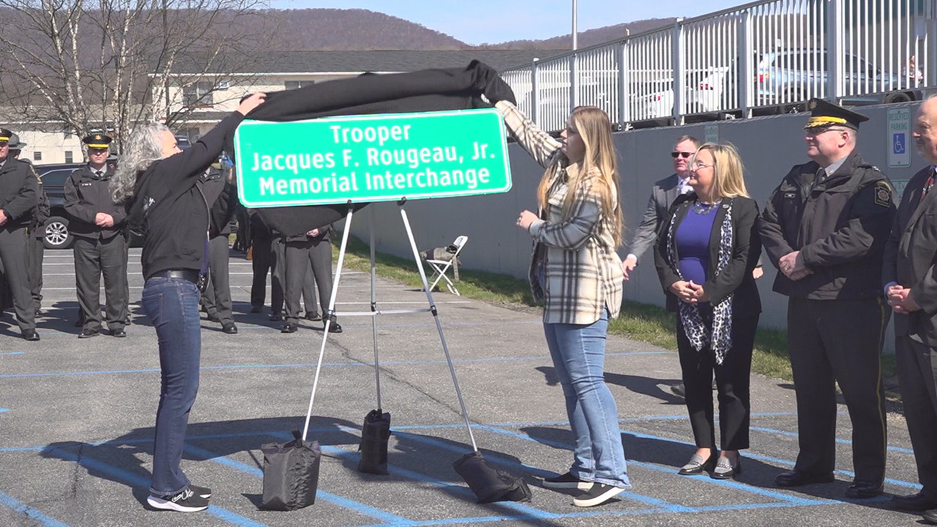 State troopers came together to unveil a new highway sign dedicated to Trooper Jacques Rougeau, who was killed in June 2023.