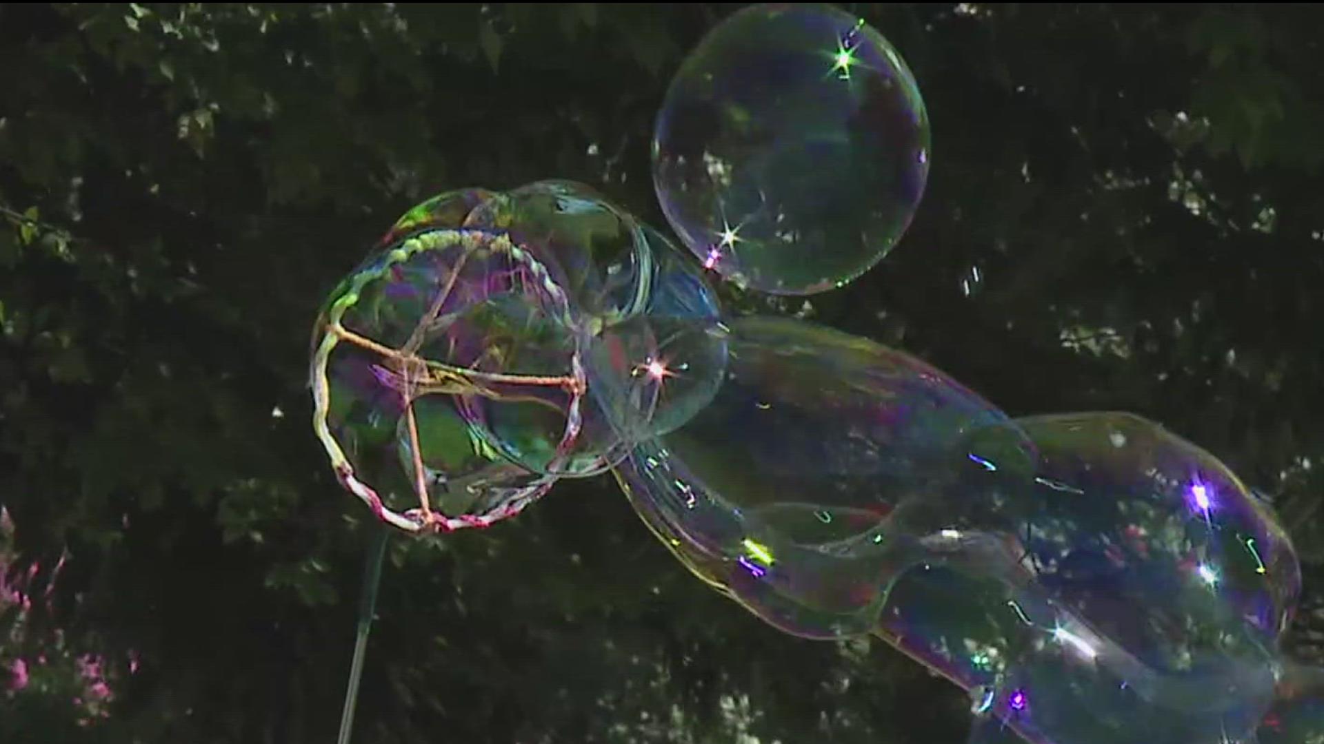 A Phoenixville, Pa., man makes his own hand-made bubble juice to create giant life-sized bubbles at Kipona Festival.