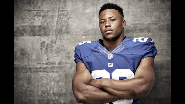 Download Saquon Barkley in action on the field Wallpaper