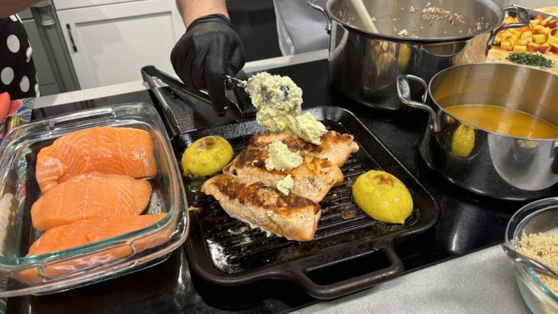 Grilled salmon is served over toasted Walnut and Wild Mushroom Risotto along with steamed broccoli. Everything then gets topped with a fresh Honey Peach Chutney.