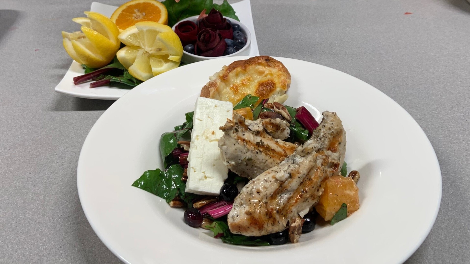 Olivia's demonstrates how to make their new summer salad that features fresh garden beets and is topped with fire-grilled chicken breast.