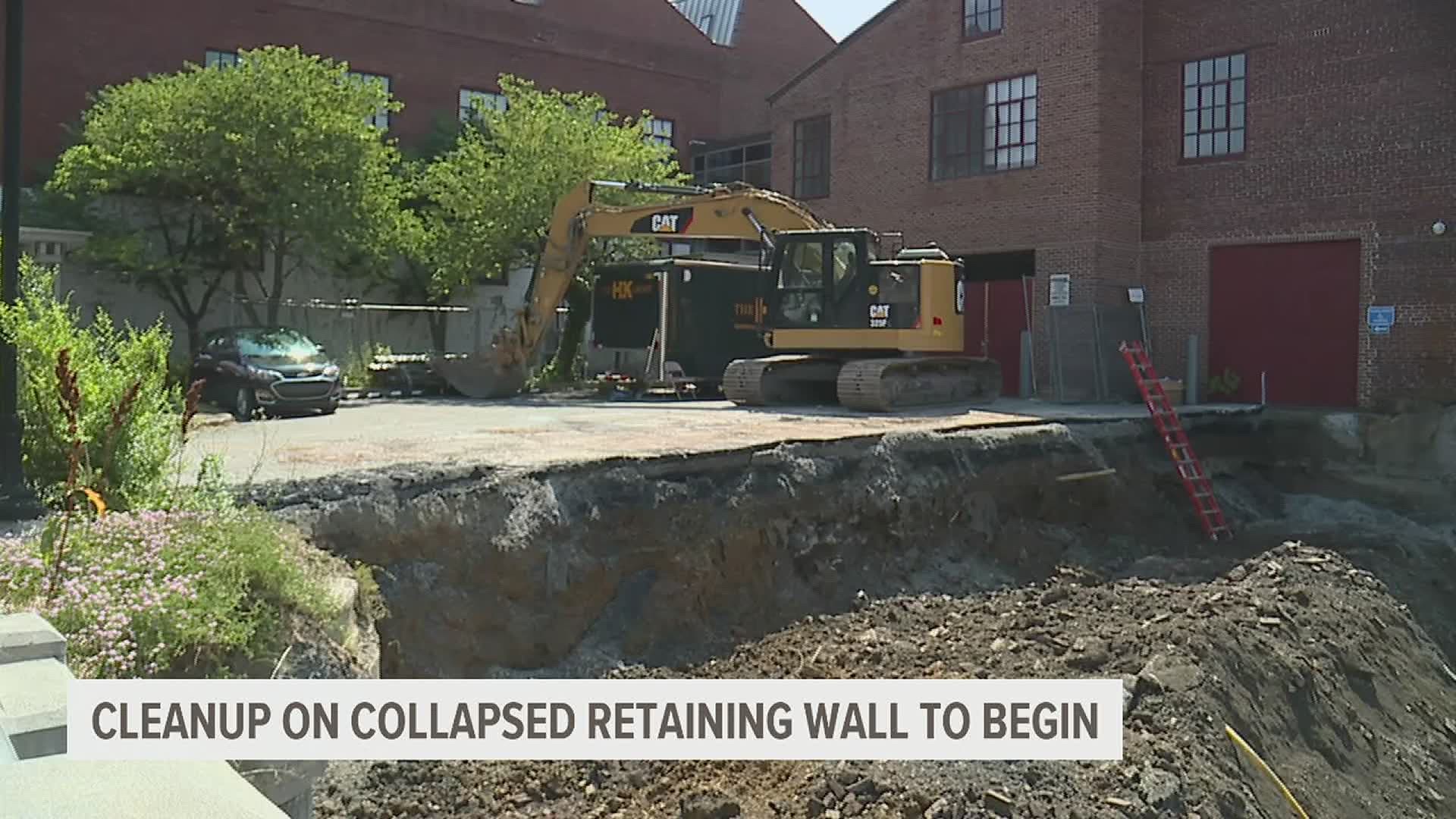It's been five years since a retaining wall above Howard Tire and Auto collapsed. Today, clean-up began.