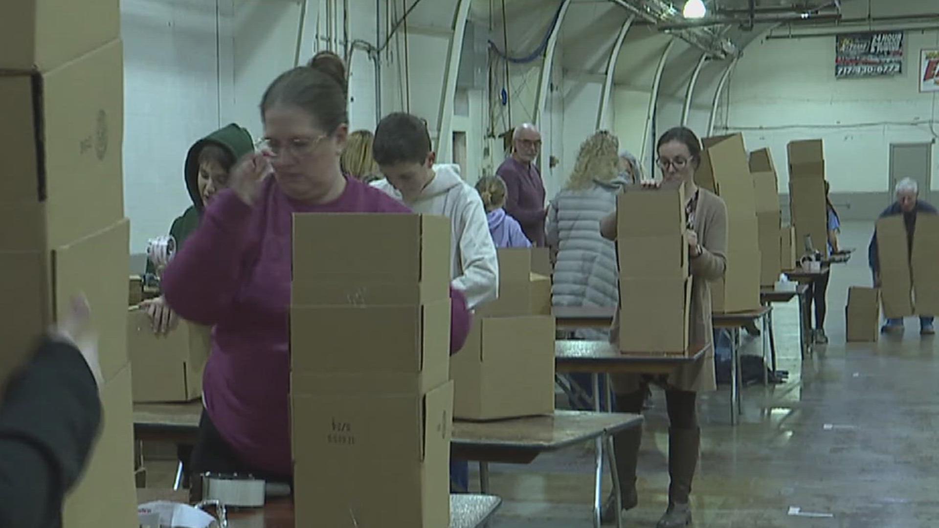 Volunteers with YorkGiving spent Wednesday evening making boxes at the York Expo Center in Manchester Township. 