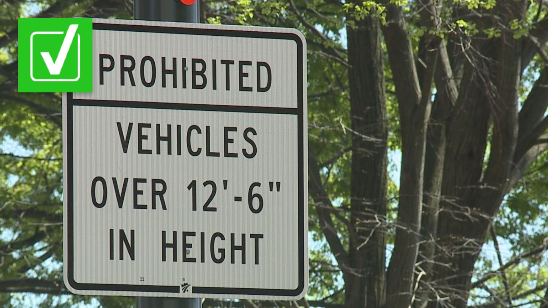 The city first added signs prohibiting trucks over 12-feet-6-inches from going under the train bridge.