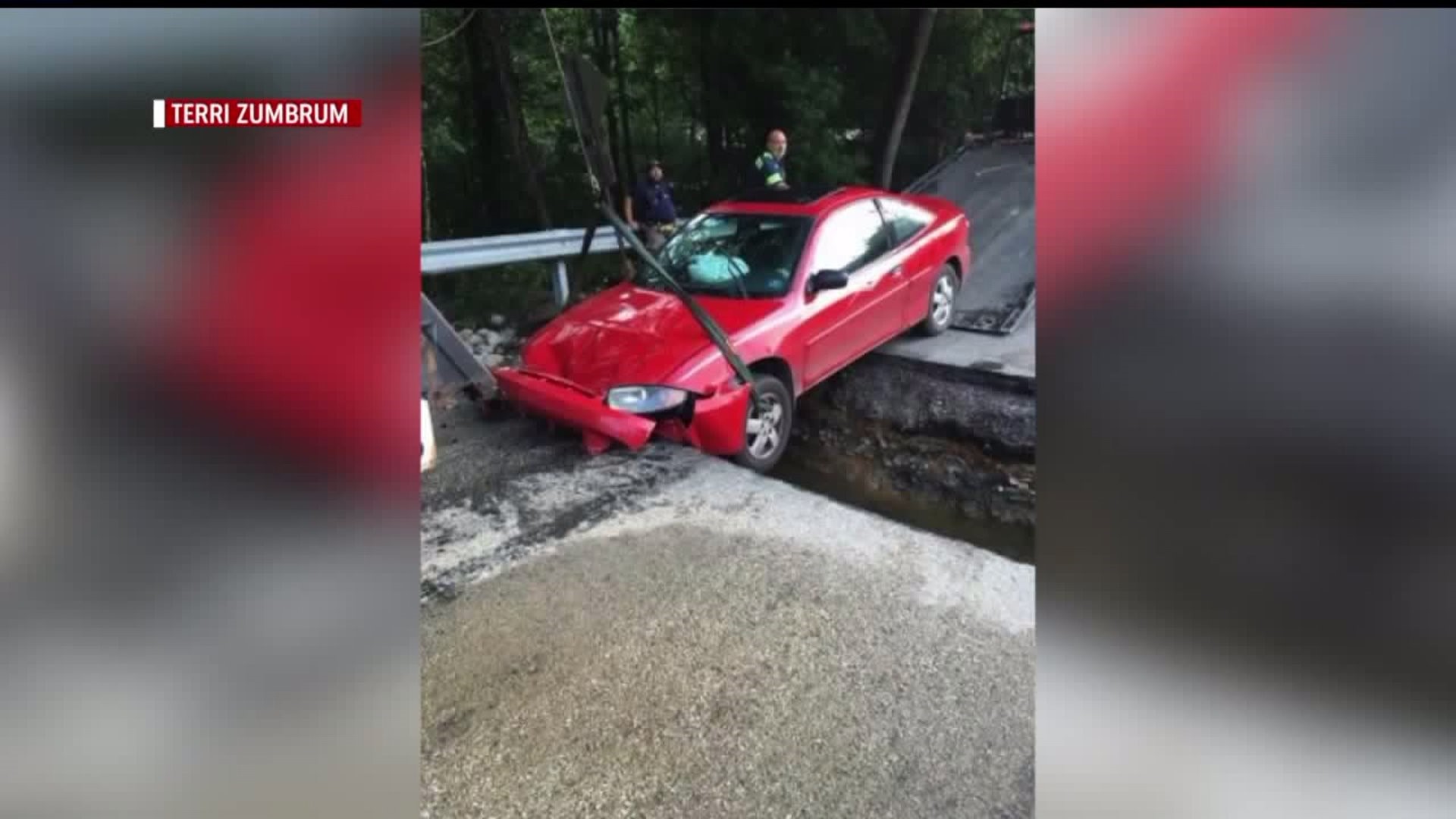 CAR CRASHES INTO FLOODED ROADWAY AFTER CLOSED ROAD SIGN IS REMOVED