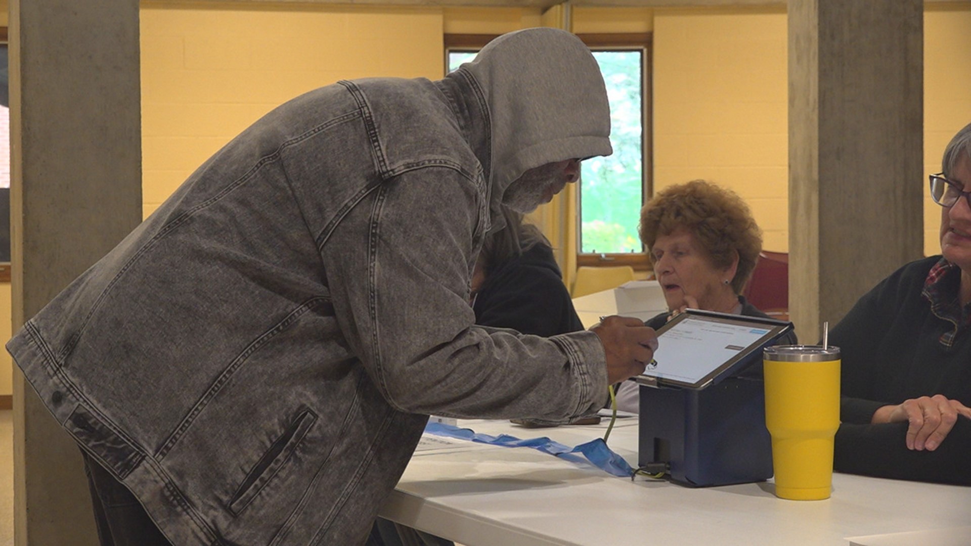 Poll workers at a dozen polling stations signed in voters using E-poll books, as part of a county-wide study to improve wait times.