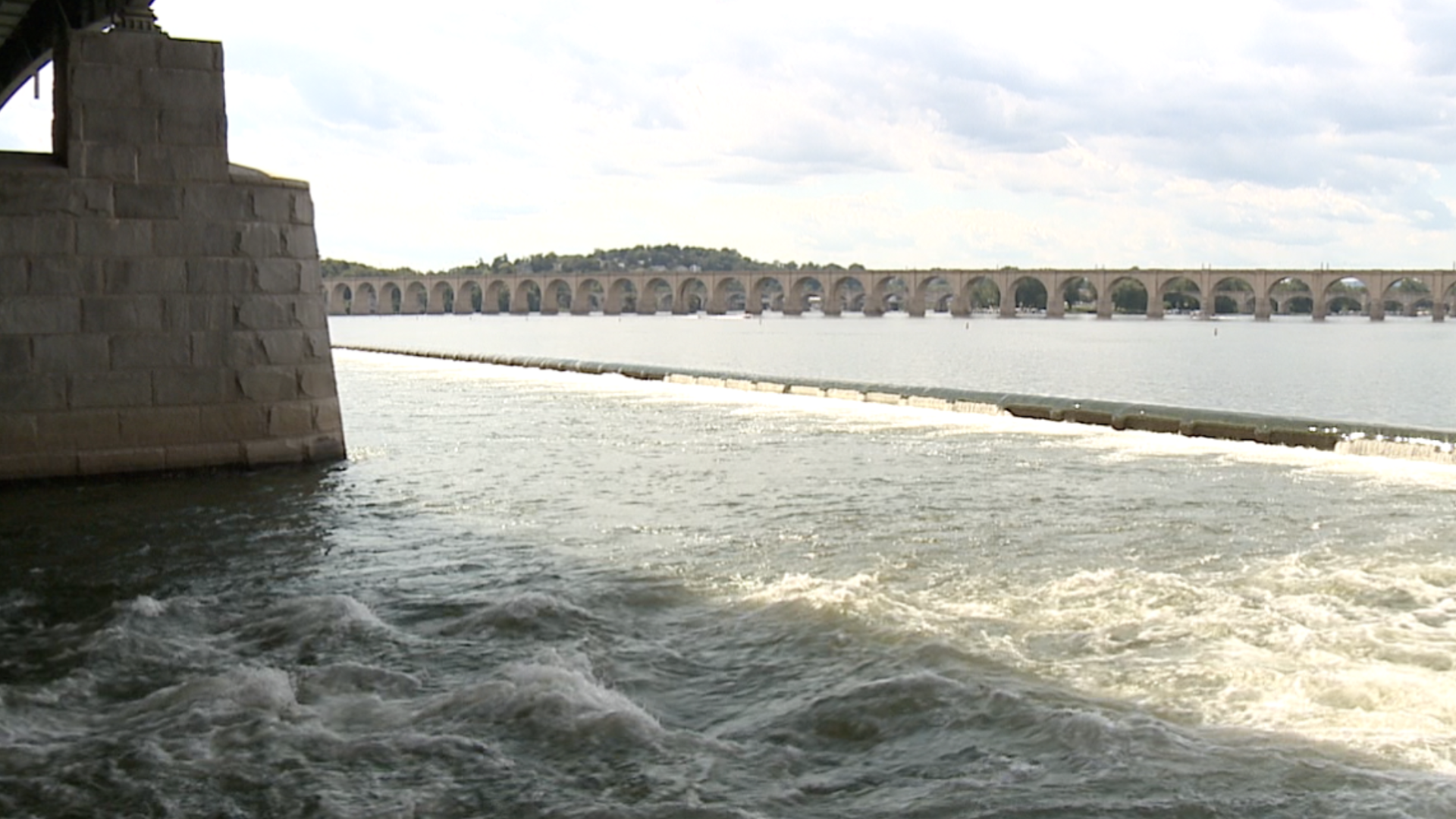 Authorities say a man held a woman at knifepoint while atop a vehicle in the Susquehanna River.