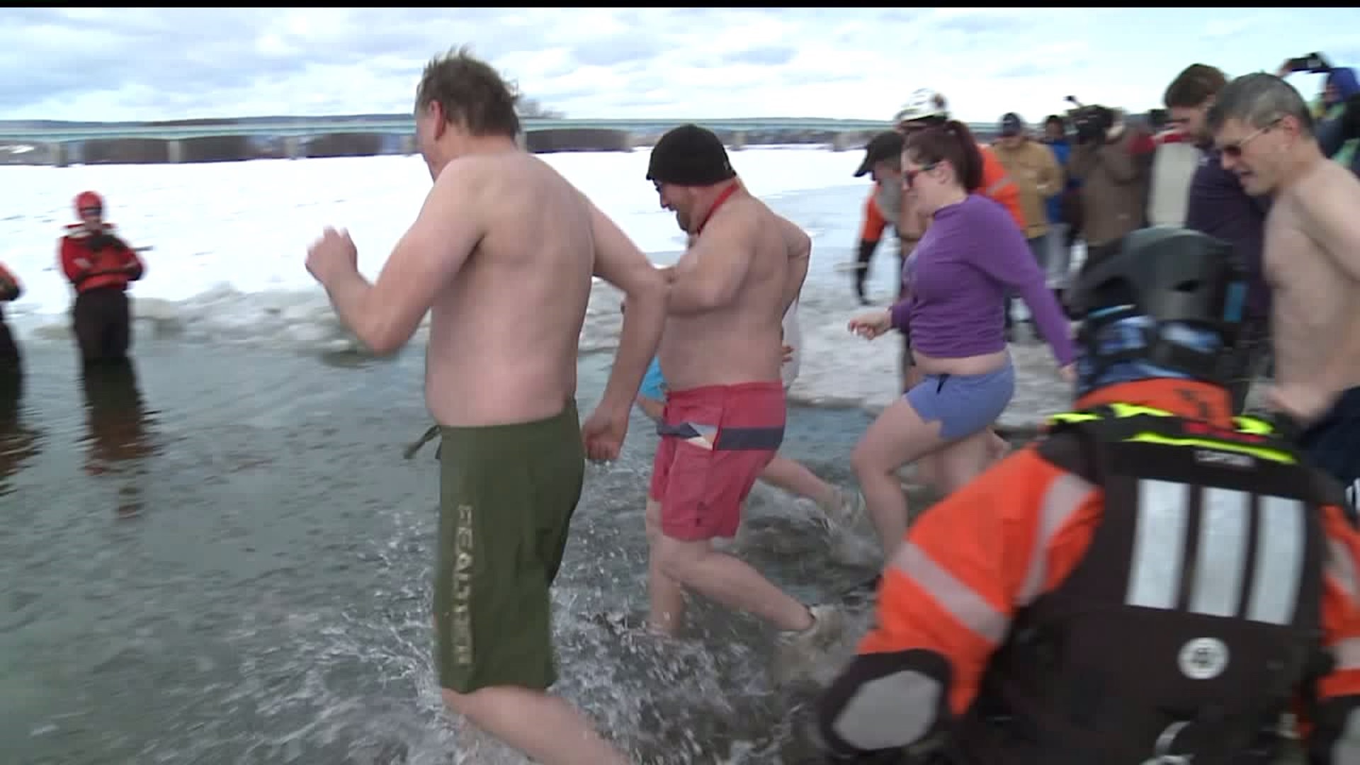 Crowd takes "penguin plunge" despite frigid temperature