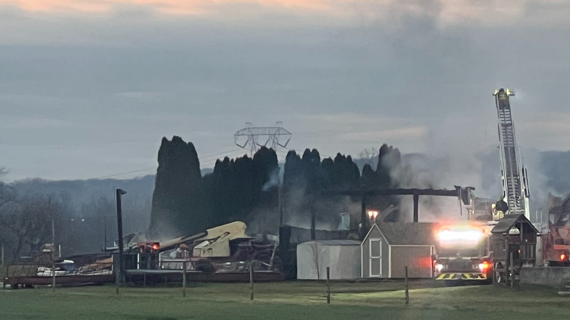 Firefighters say a heat lamp set up to keep puppies warm in a barn ignited hay in the building and started the early-morning fire.