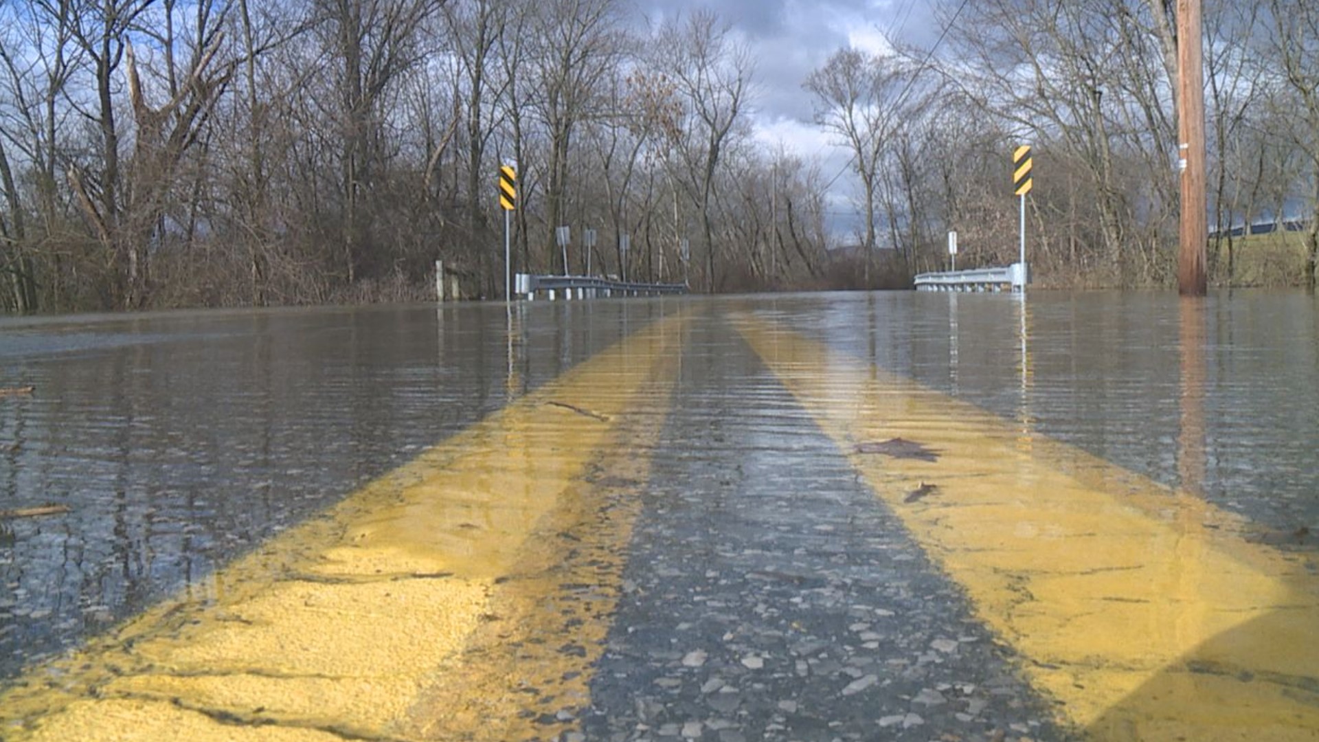 Heavy rain causes local streams to overflow and flood nearby streets.