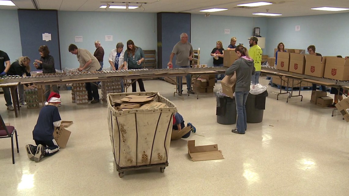 Volunteers pack boxes of food for Salvation Army Christmas Cheer