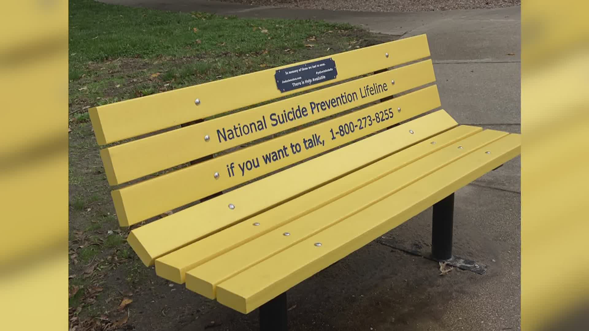 The yellow bench was installed in upper Longview Park and includes a National Suicide Prevention Lifeline phone number and message.