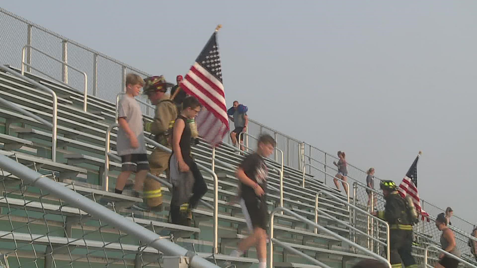 Community members, local firefighters and police officers gathered at Geneseo High School to climb the bleachers in honor of those who lost their lives on Sept. 11.