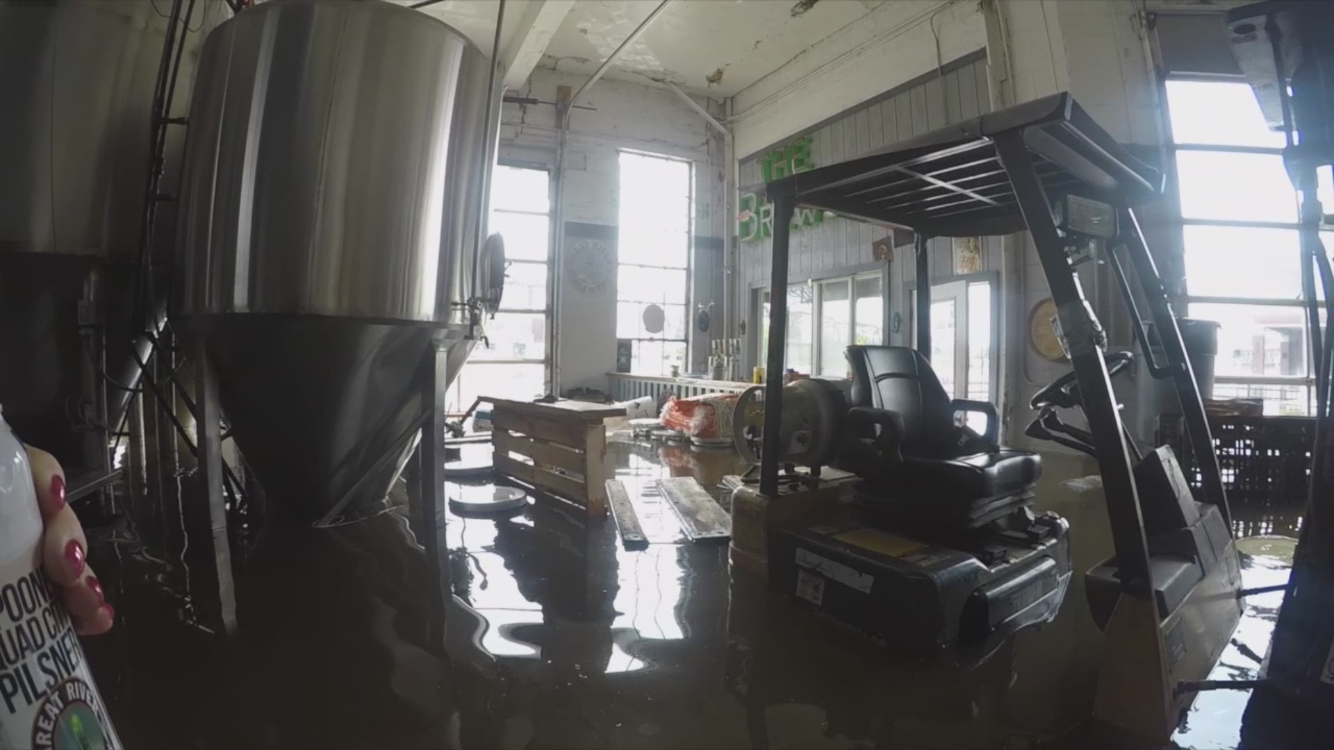The owners of Great River Brewing Company take a first-look inside the building after flood waters took over the inside.