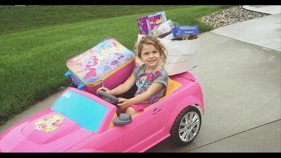 girl drives Barbie car full of gifts to who everything wqad.com