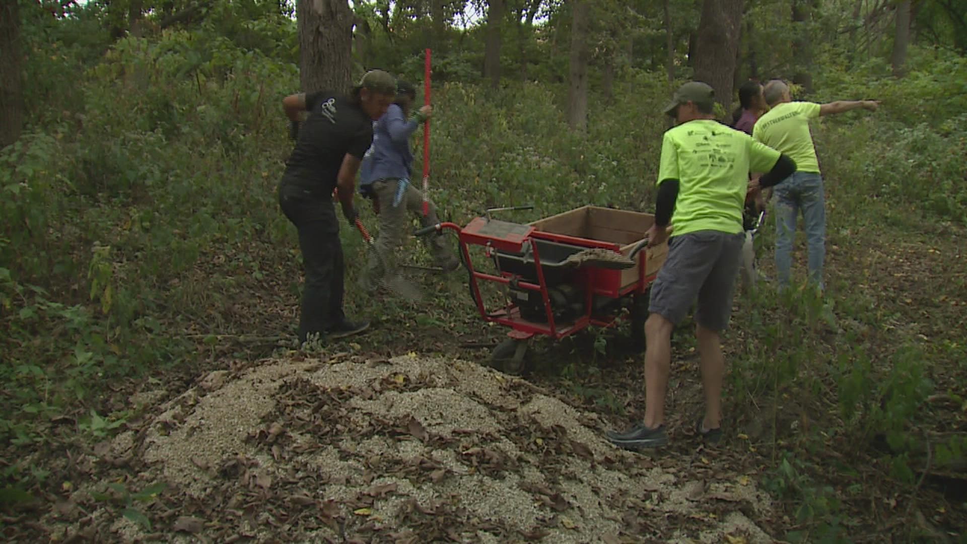 The trail, funded by a grant provided by WQAD's parent company, is close to ready, with community volunteers filling the path with rocks.