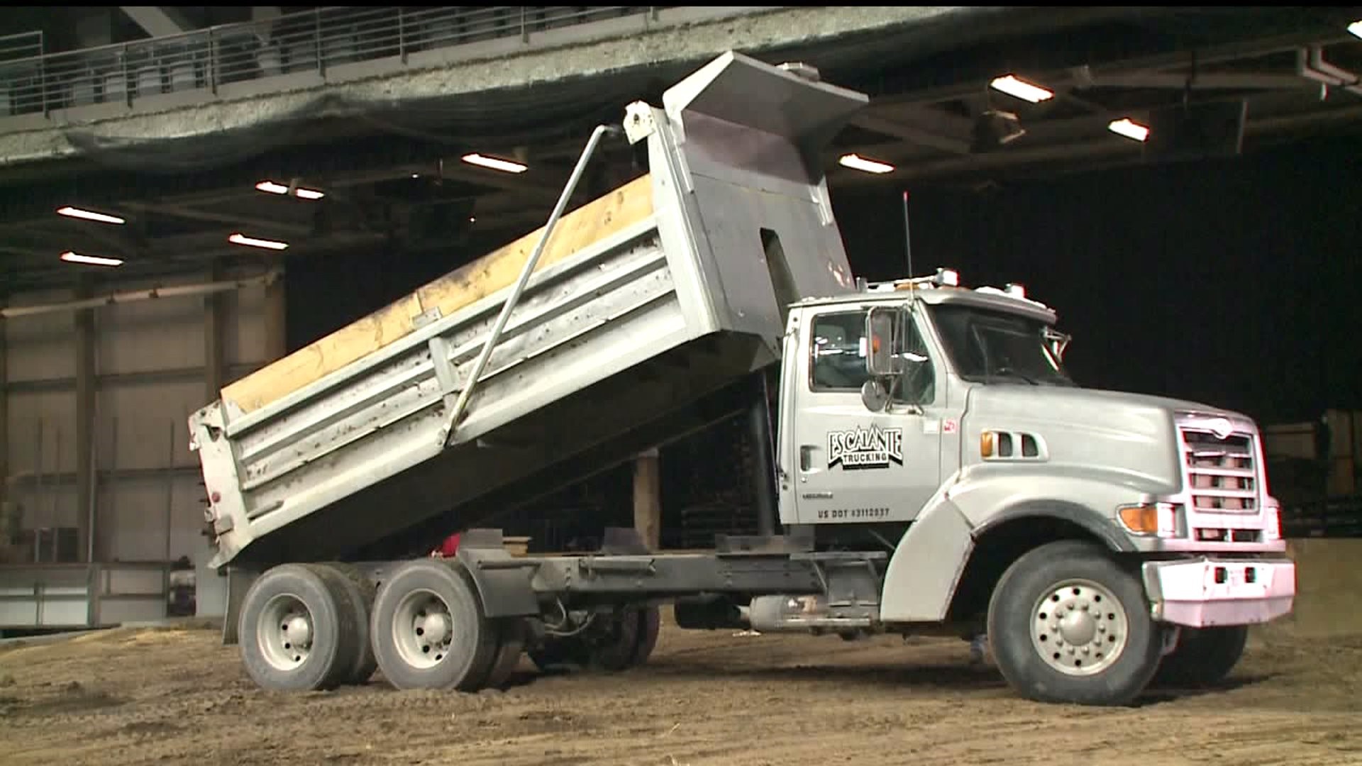 Watch: 66 truckloads of dirt poured into TaxSlayer Center