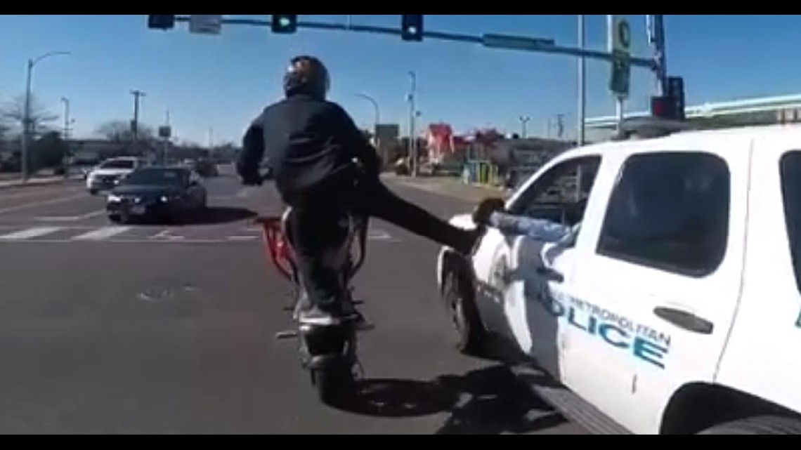 Biker gives cop fist bump with foot while doing stunts | wqad.com