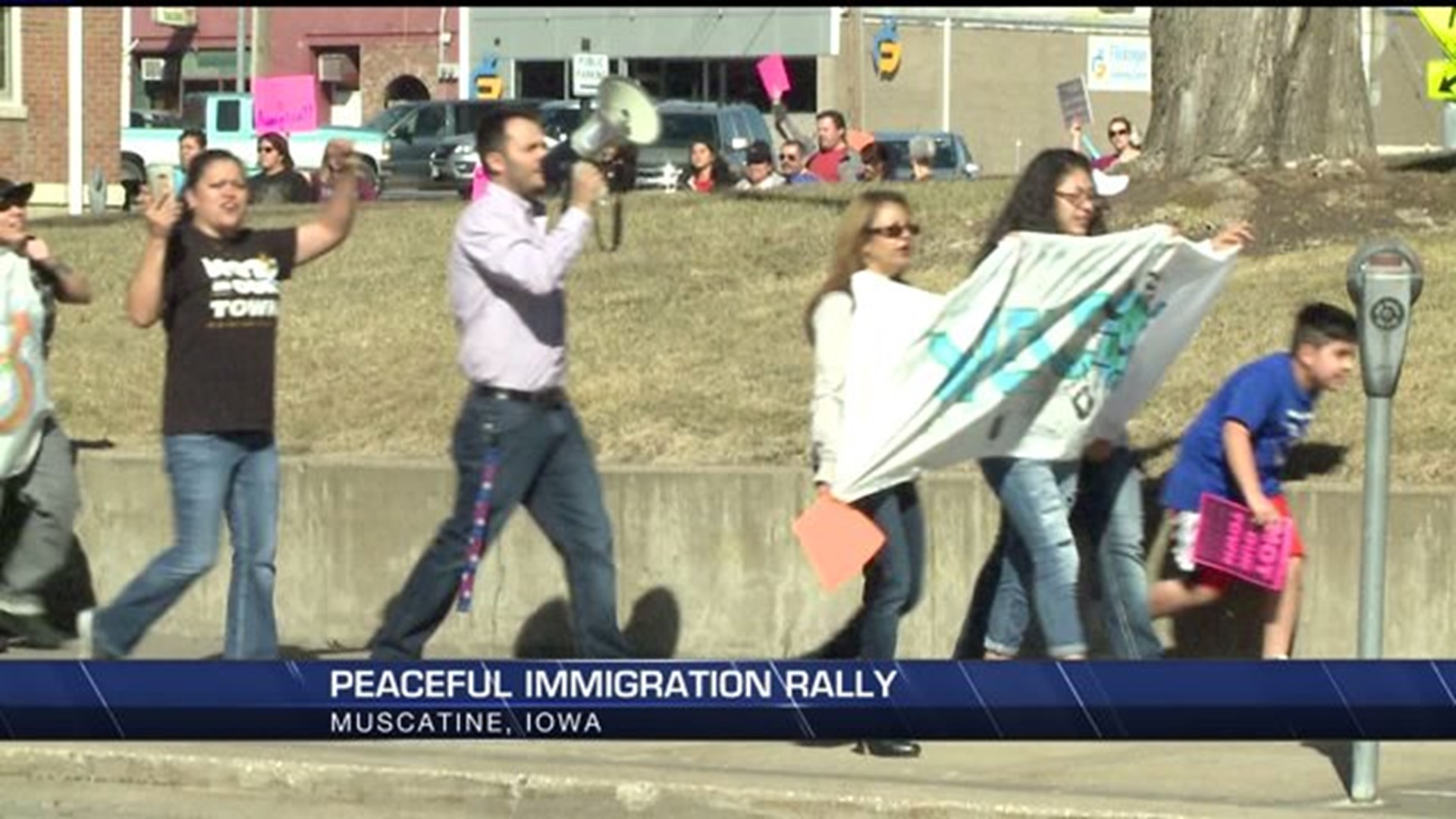 Dozens peacefully march and rally for immigrant neighbors in Muscatine