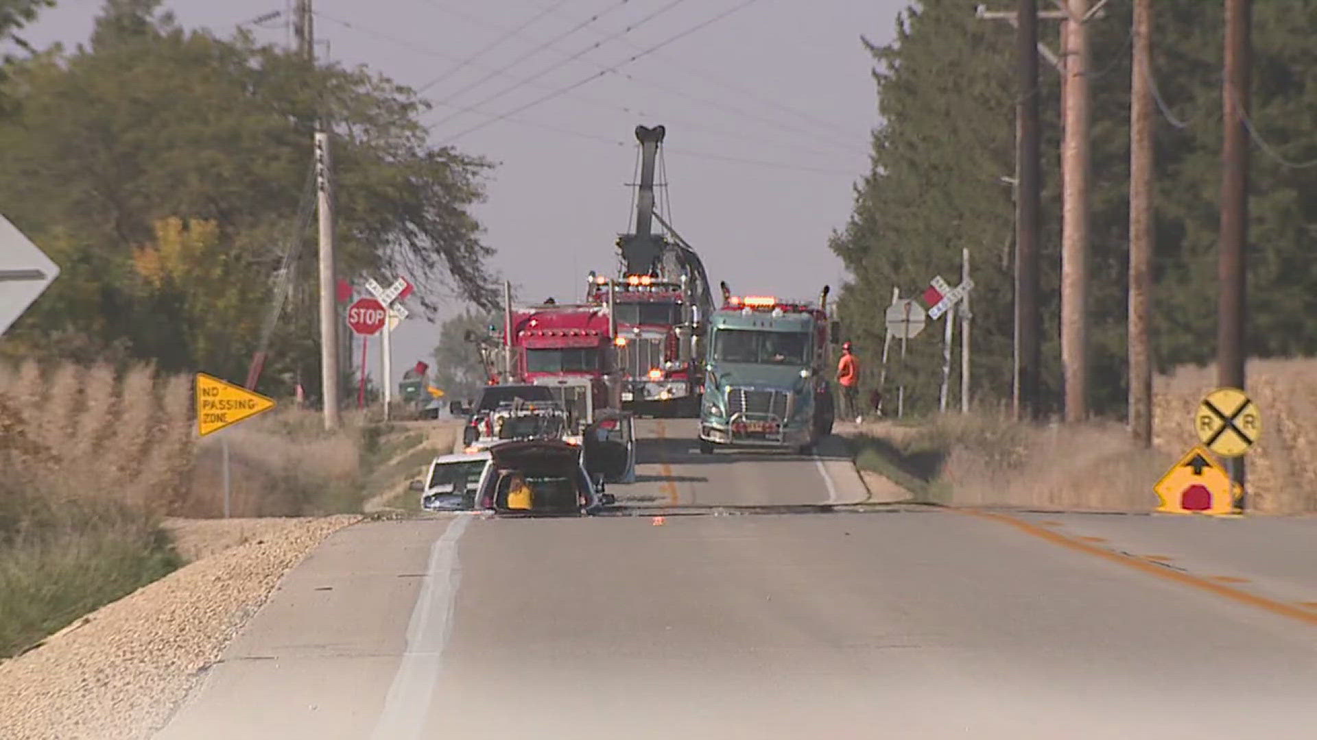 A semi-truck carrying liquid asphalt was struck by a train in rural Scott County on Wednesday, causing a spill and road closure.