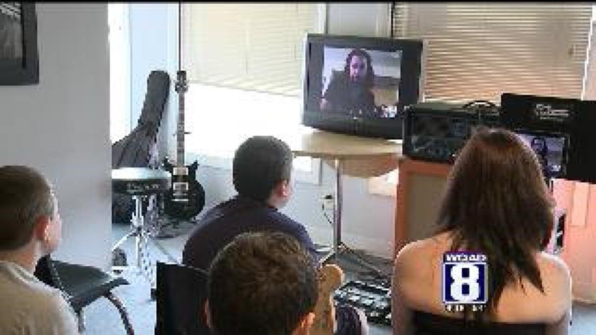 Students at Rock Academy talk to Kiss player