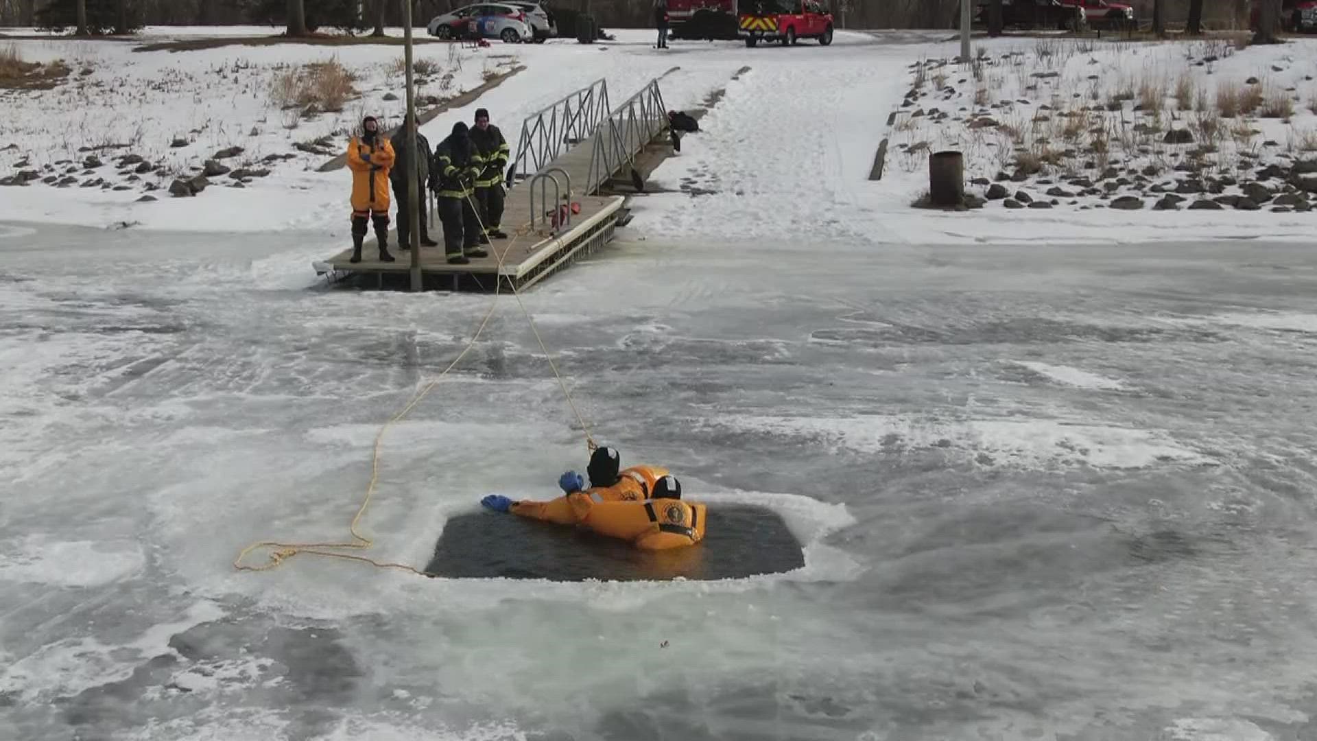 15 fire fighters took the plunge into the freezing waters to practice pulling someone out in the case of an accident