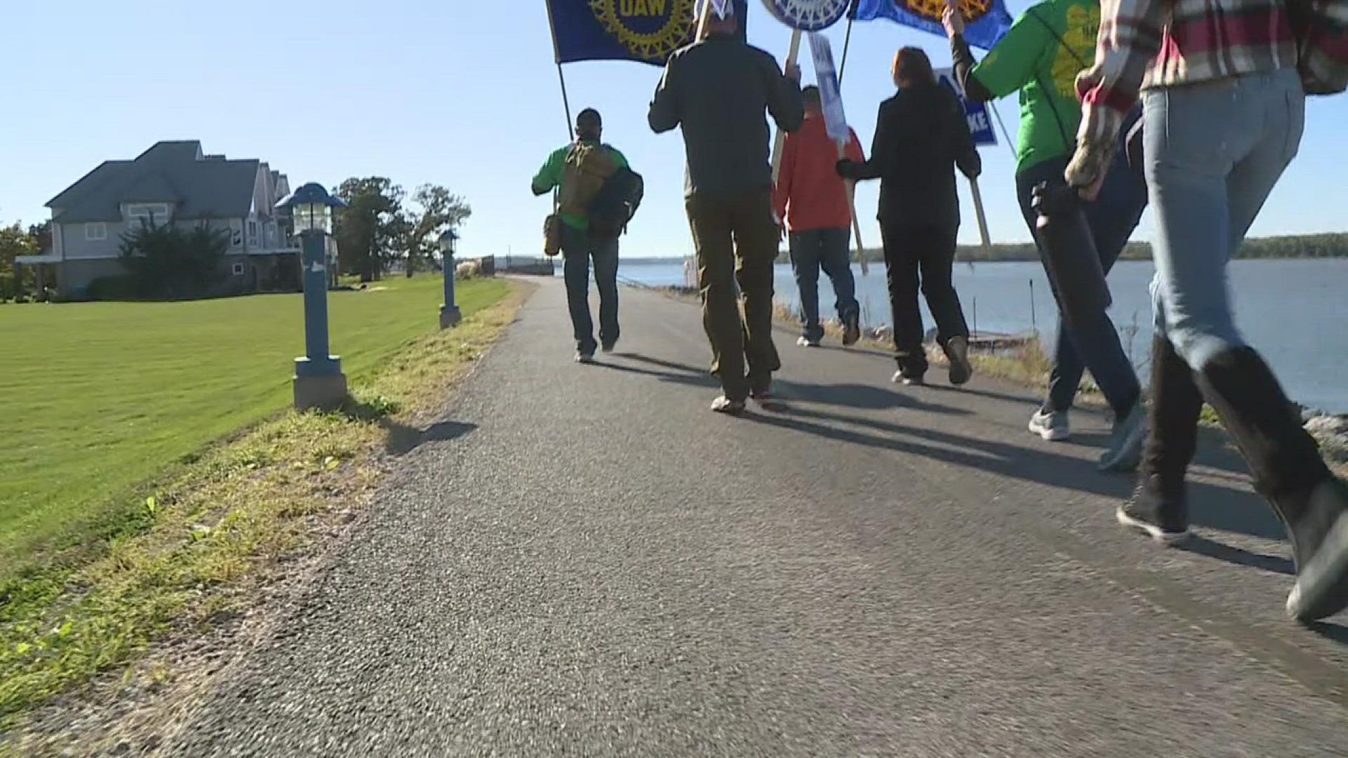 Almost 200 UAW employees and supporters walked along the Mississippi River in solidarity with John Deere strikers.