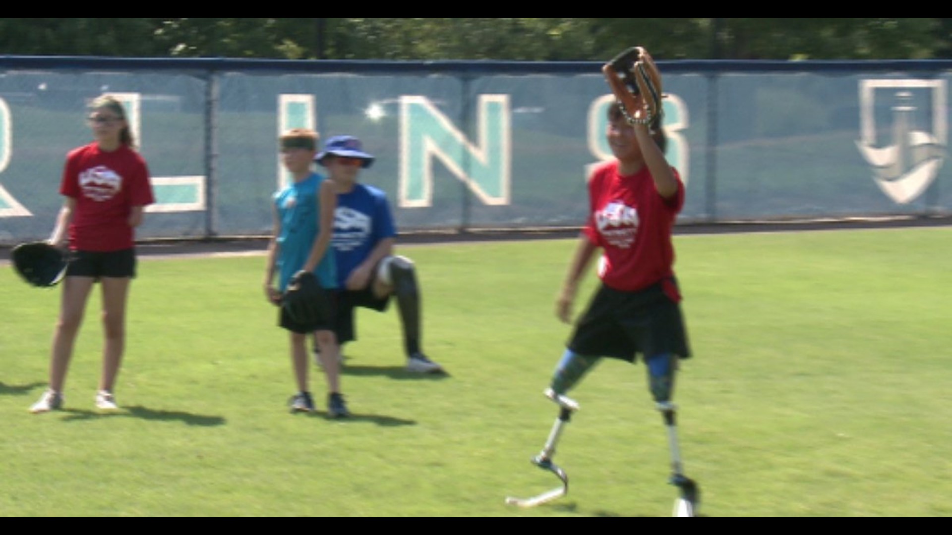 Wounded veterans teach children with missing limbs how to play ball ...