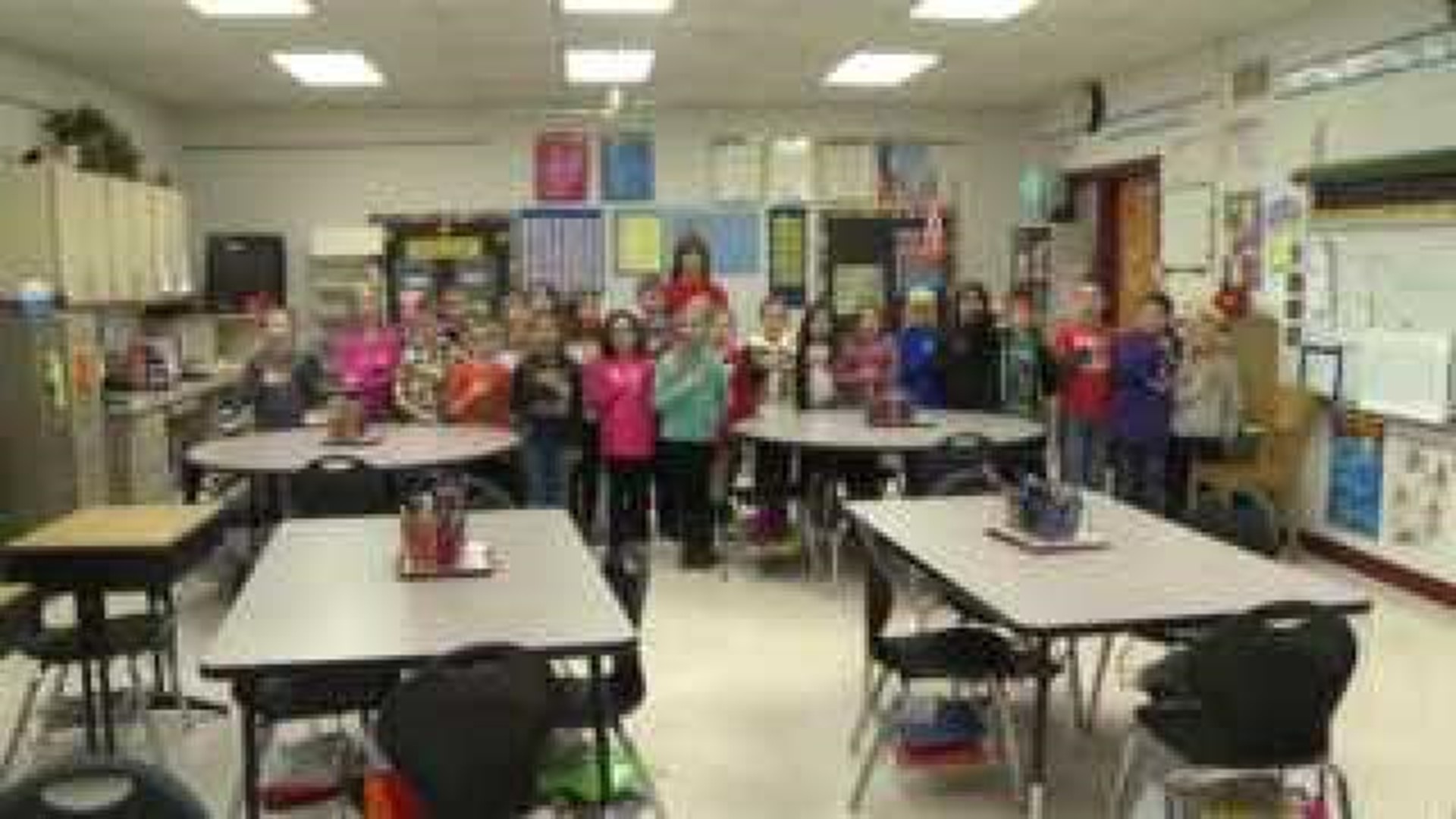 Mrs. Thoms' class says the Pledge of Allegiance