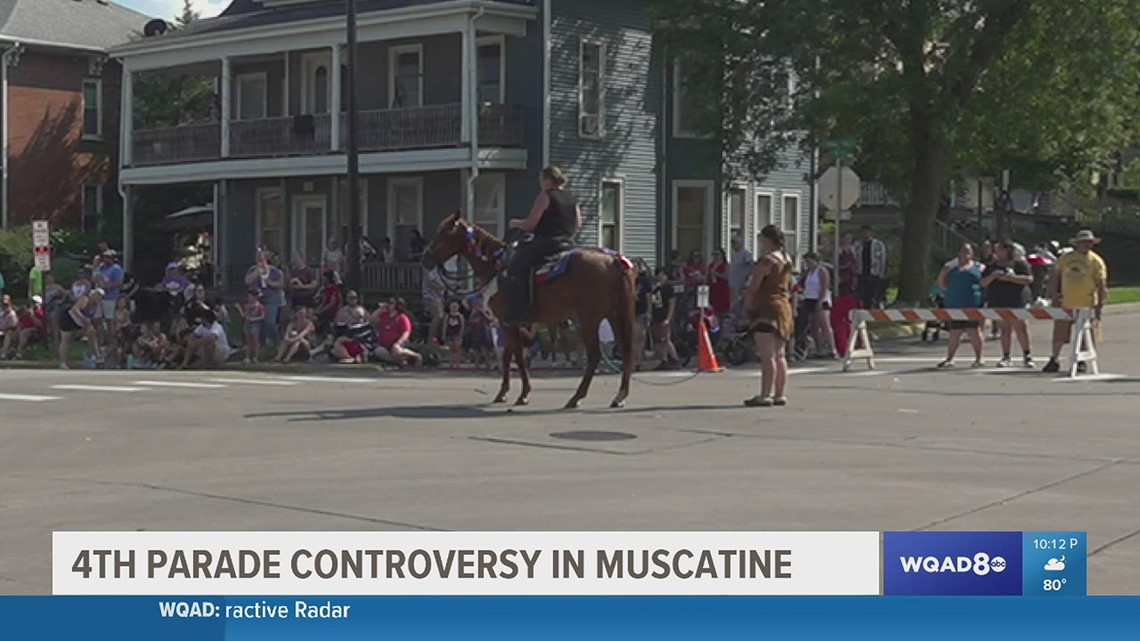 Muscatine parade features woman dressed as Native pulled by rope