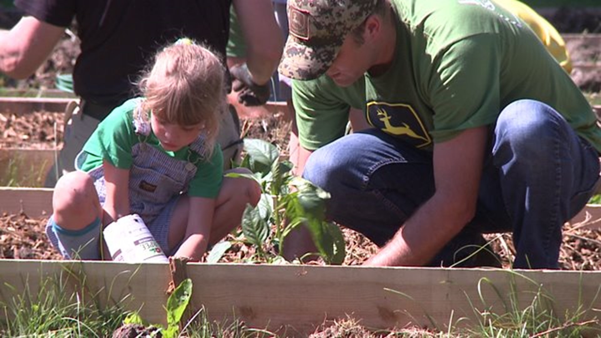 Volunteers plant garden