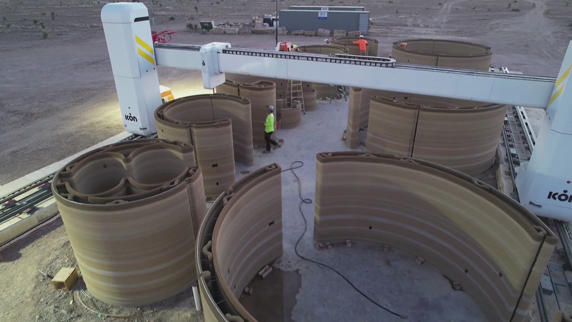 An industrial-size 3D printer lays layer after layer of a concrete to form the walls of the hotel's first two model units in Marfa, Texas.