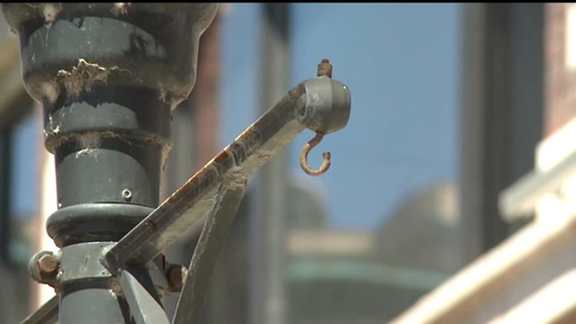 Hanging flower baskets go up Saturday in downtown Davenport