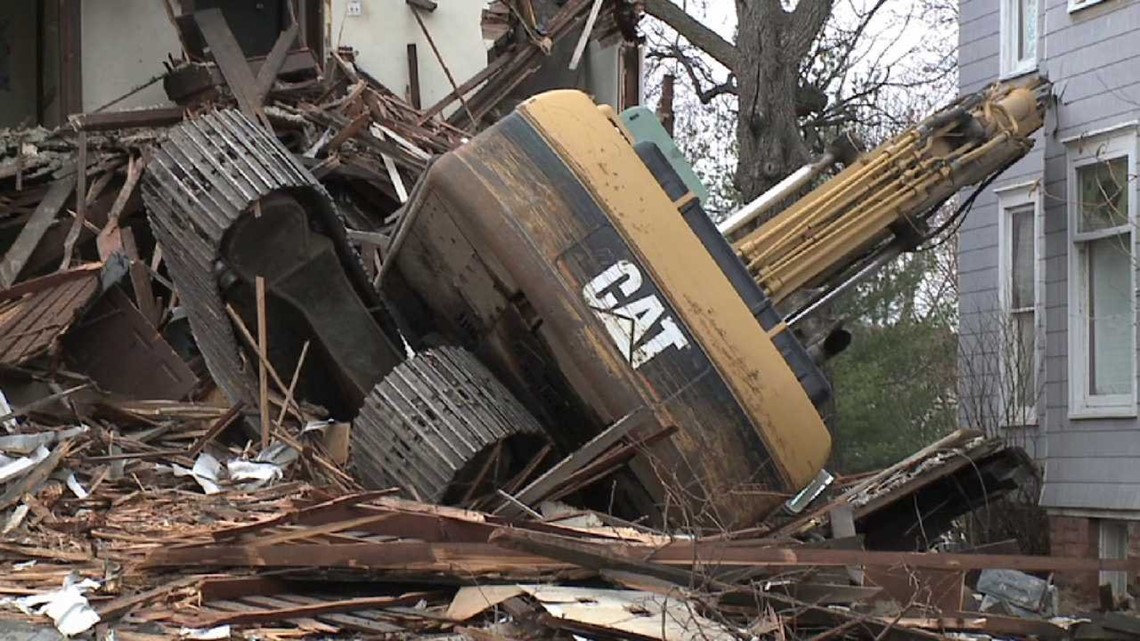 Photos Backhoe tips over in demolition accident