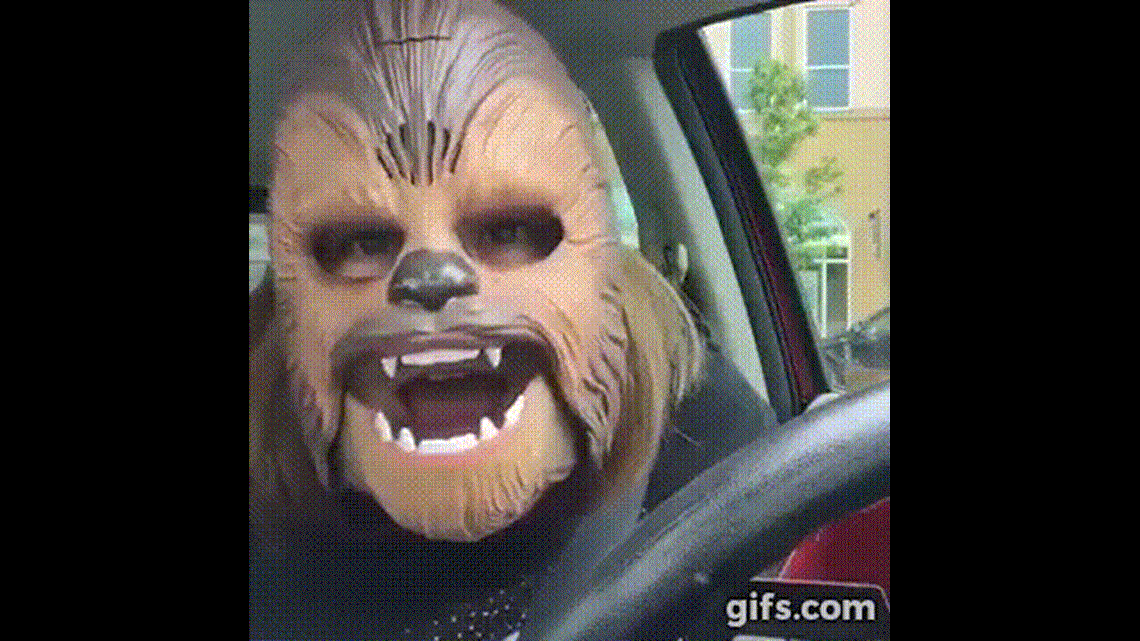 Woman laughs hysterically at herself in Chewbacca mask