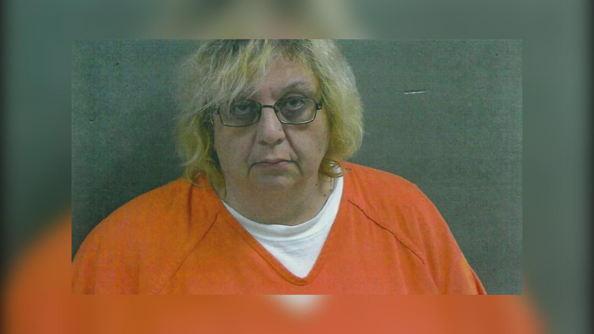 50-year-old Marcy Oglesby, who lives across the street from where the body was found, was arrested and charged with concealment of death.