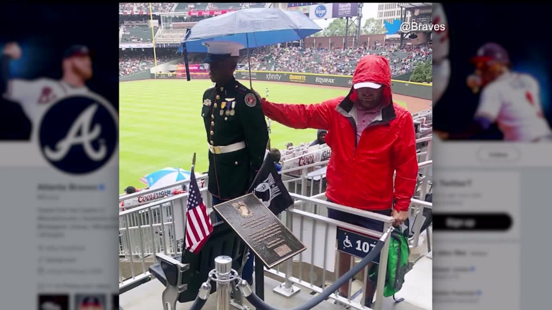 Baseball fan stands in rain to hold umbrella over JROTC member