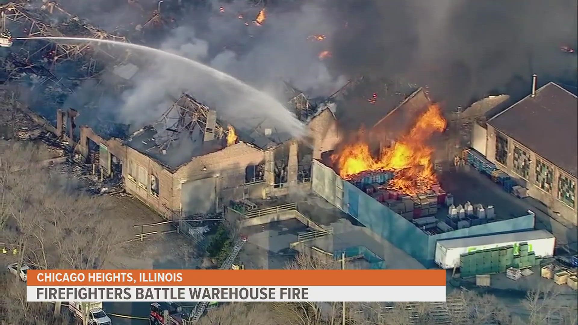 Chicago area firefighters are trying to contain a huge warehouse fire that filled the sky with smoke.