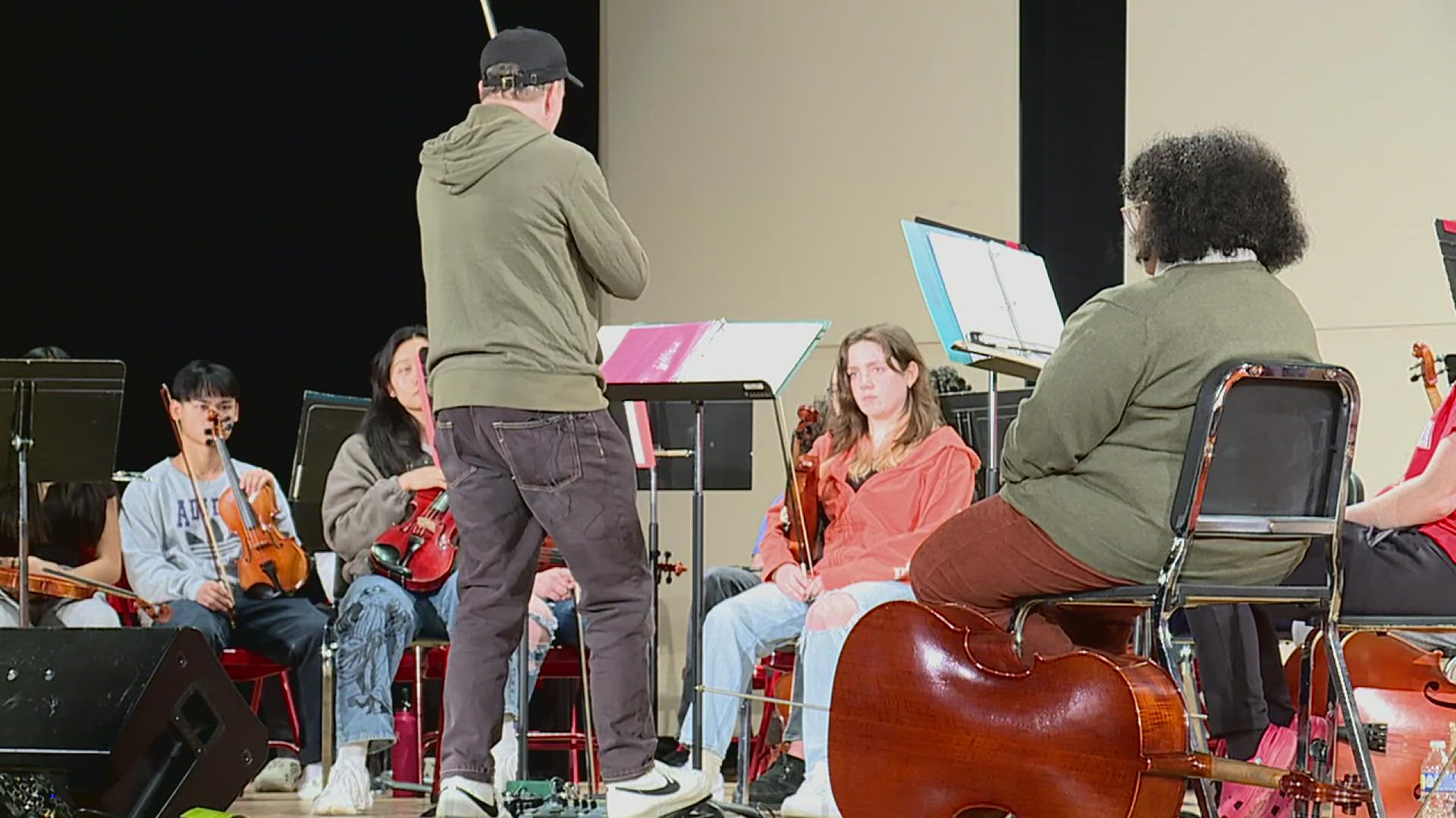 Tracy Silverman, a globe-trotting electric violin player, practiced with the student band, showing them tricks and different types of music to play.