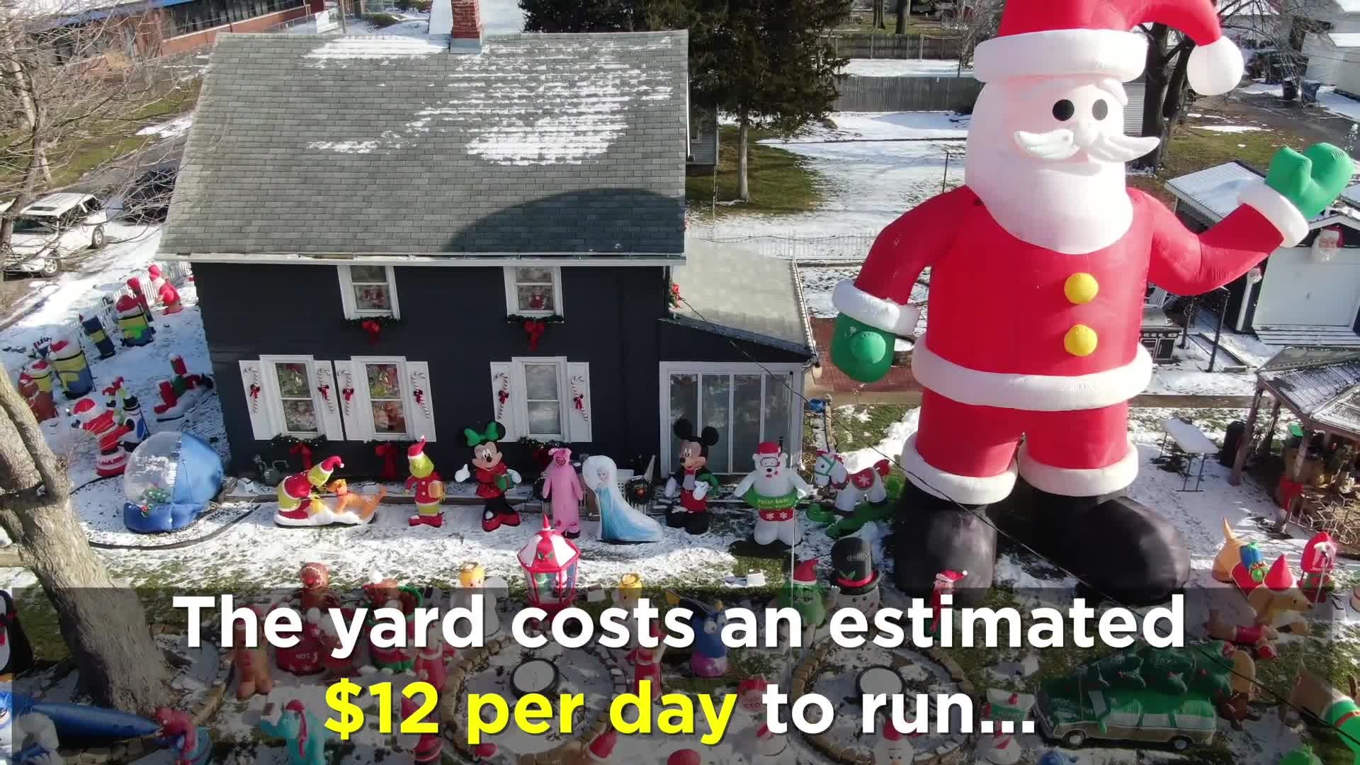 Inflatable Santa in Moline Christmas display is taller than the house