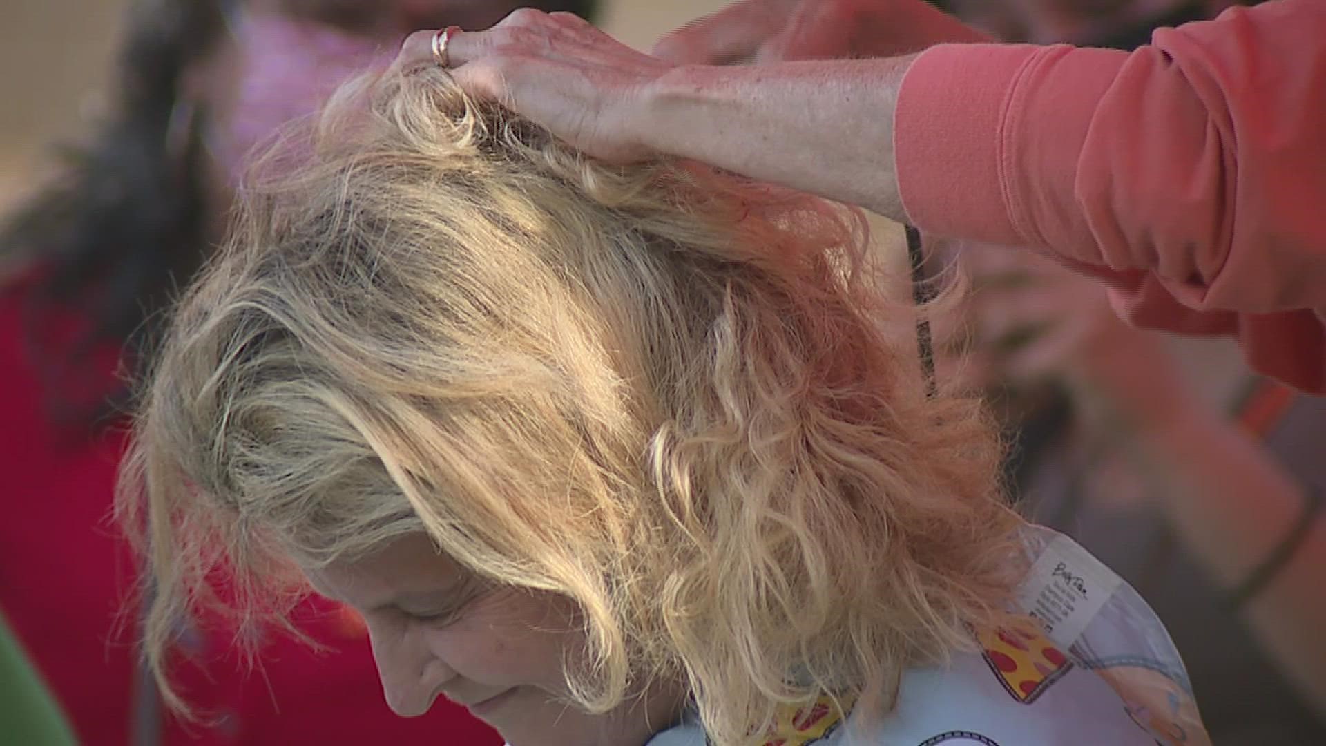 A few staff members at Denkmann Elementary School shave their heads as a 6th grader undergoes treatment for Leukemia.