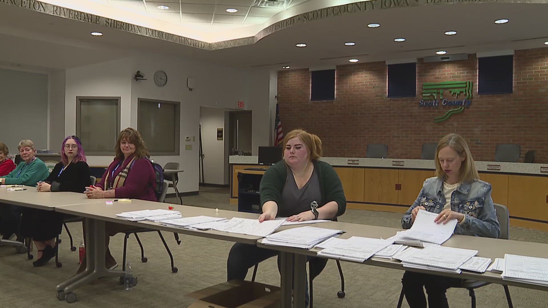 A group of election officials hand-counted votes cast at a randomly selected precinct to ensure they matched the machine count.