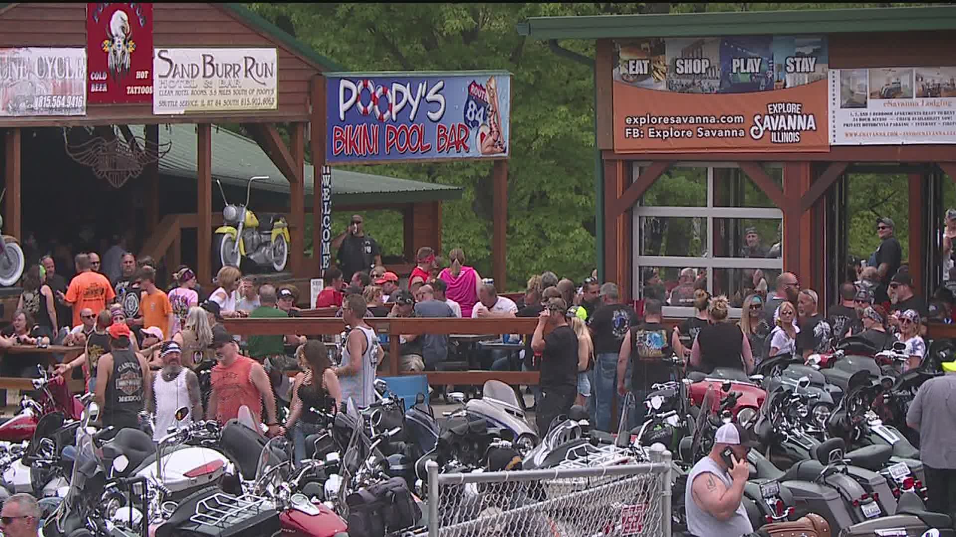 As hundreds of revelers disregard social distancing guidelines, the owner of Poopy's Pub says "I'm not trying to be an outlaw."