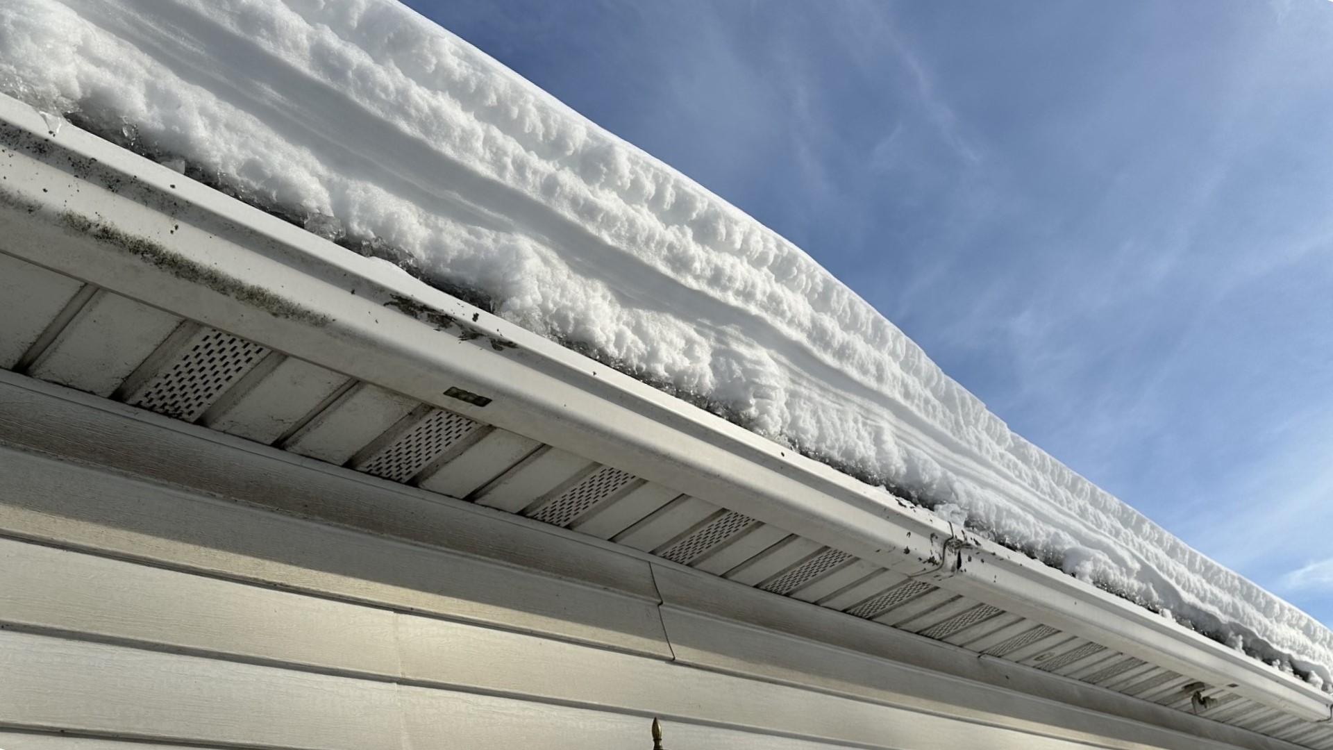 While it's dangerous for many to get on the roof and clear off the snow, some roofing companies say getting most of that snow off can save families money later.