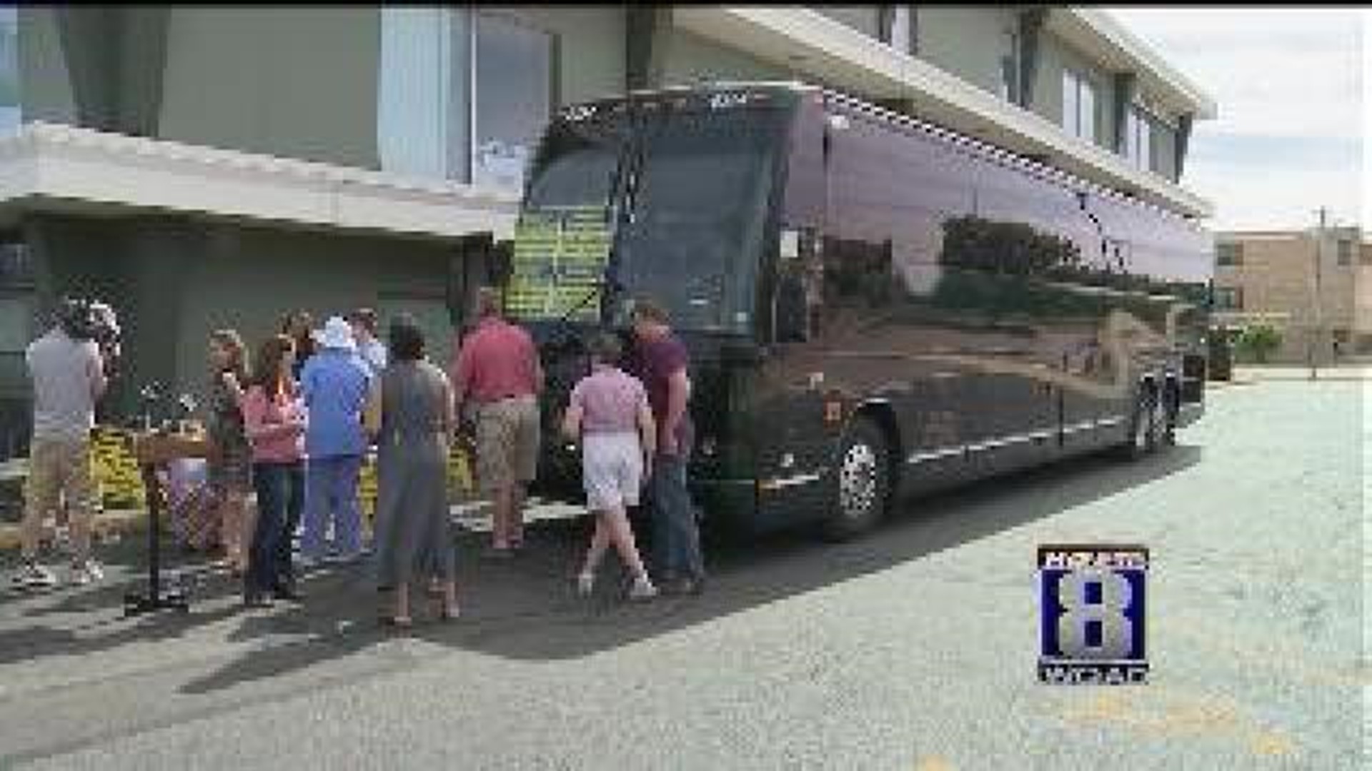 Democratic bus party stop in ahead of Romney visit
